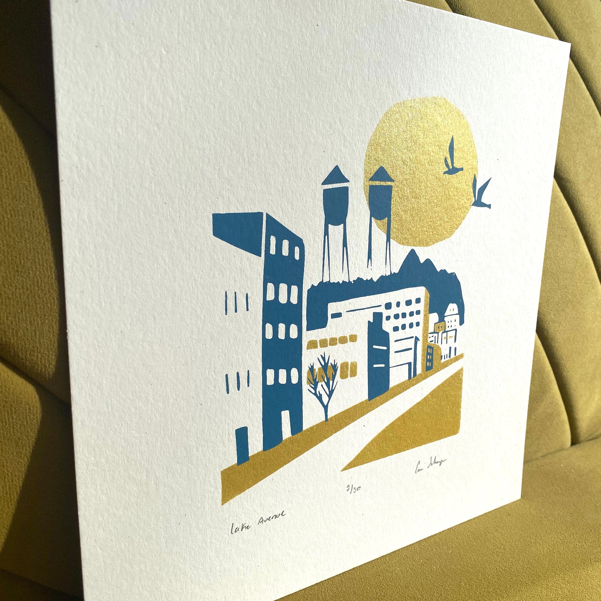 Modern minimal art print of Lake Avenue, Canal Park MN. Blue & gold ink. titled, numbered and signed. Side view showing shimmering sun & gold ink